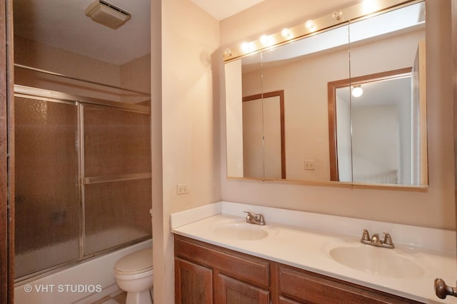 full bathroom with shower / bath combination with glass door, vanity, and toilet