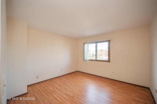 spare room with light hardwood / wood-style floors