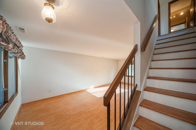 stairs featuring hardwood / wood-style flooring