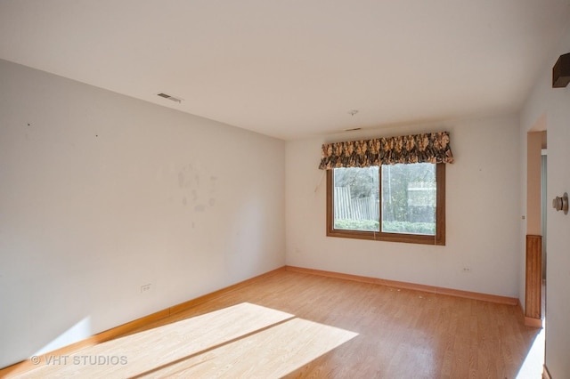 unfurnished room featuring hardwood / wood-style floors