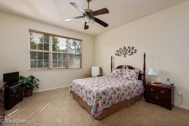 bedroom featuring a ceiling fan, light colored carpet, and baseboards