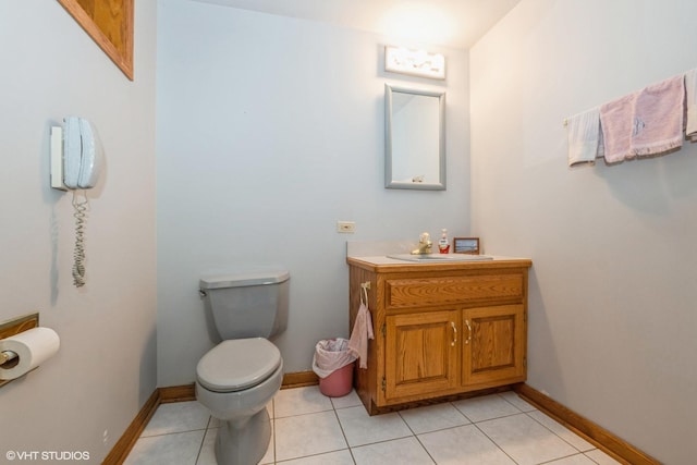 bathroom with tile patterned flooring, vanity, and toilet