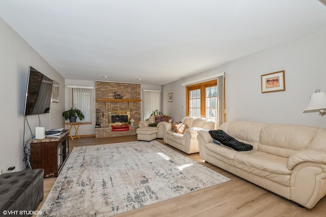 living room with a fireplace and light hardwood / wood-style flooring