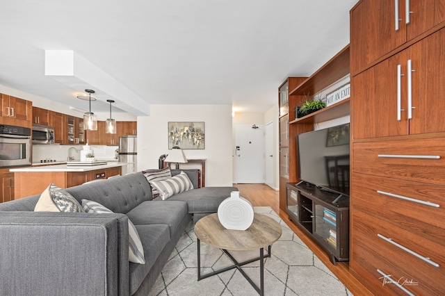 living room with light hardwood / wood-style floors and sink