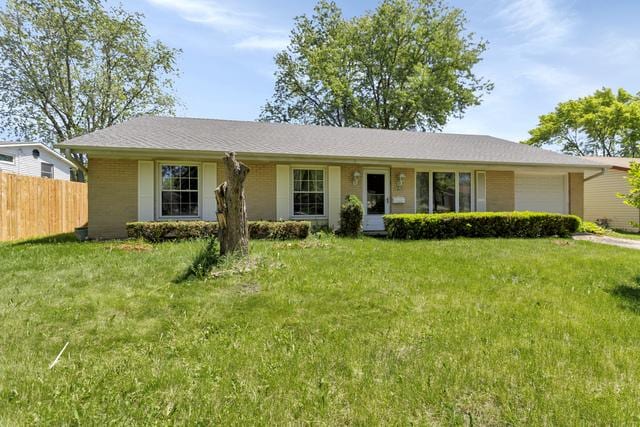 ranch-style home featuring a front yard and a garage