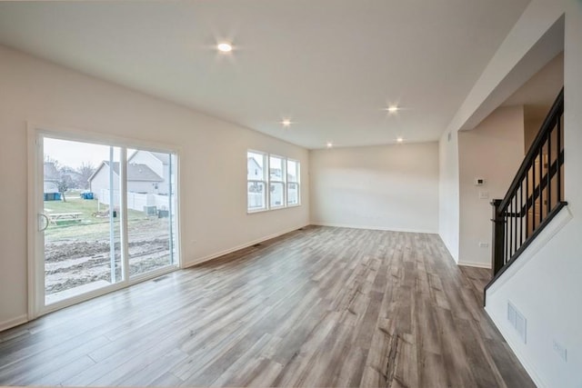 unfurnished living room with light wood-type flooring and a wealth of natural light