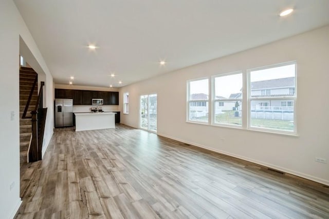 unfurnished living room with light hardwood / wood-style flooring