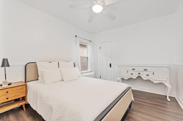 bedroom with ceiling fan and dark hardwood / wood-style flooring