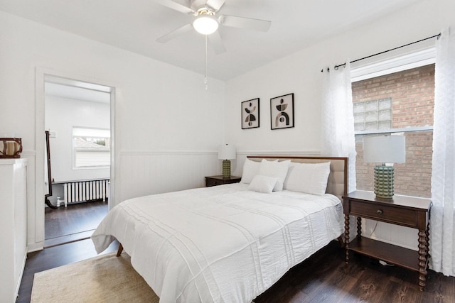 bedroom featuring radiator, ceiling fan, and dark hardwood / wood-style floors