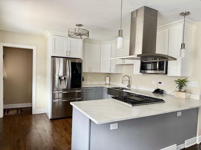 kitchen featuring sink, appliances with stainless steel finishes, decorative light fixtures, kitchen peninsula, and island exhaust hood