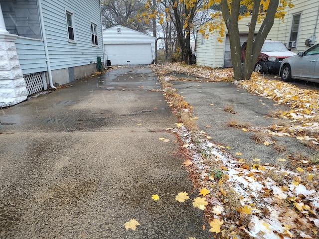 view of side of property with a garage and an outbuilding