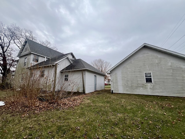 view of side of property with a yard