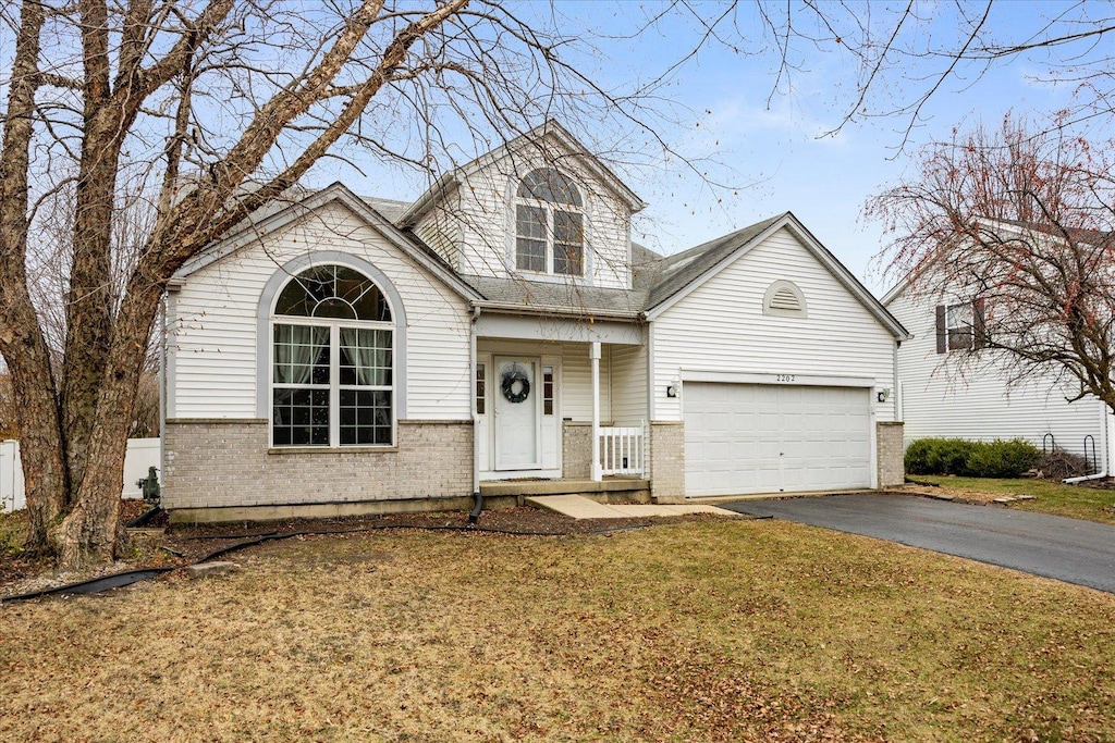 view of front facade with a garage and a front lawn