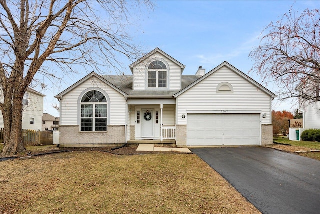 front of property with a garage and a front lawn