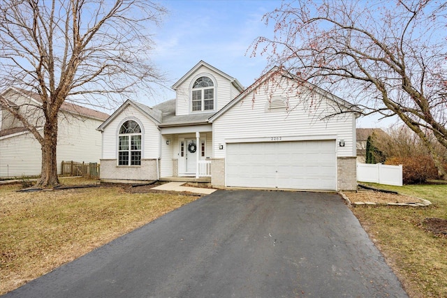 view of front property featuring a garage and a front lawn