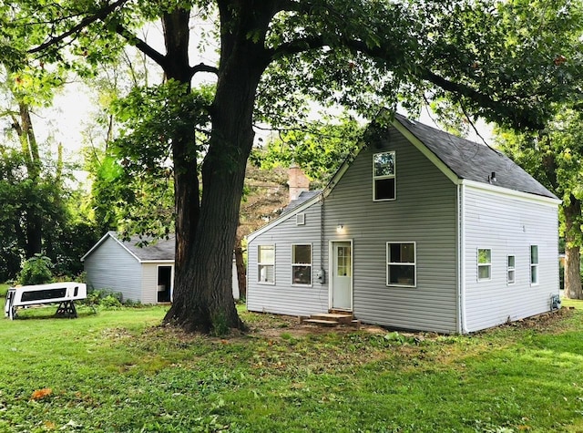 rear view of property featuring a yard