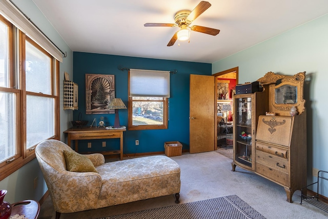 living area with ceiling fan and carpet floors