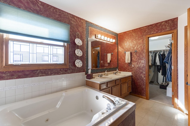 bathroom with tiled bath and vanity