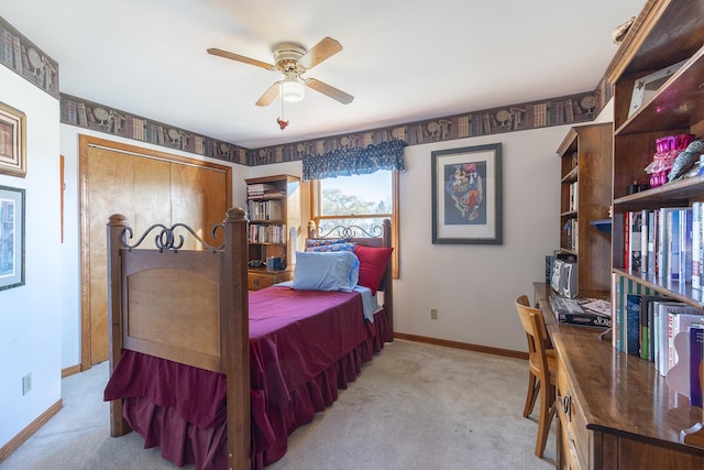 carpeted bedroom featuring ceiling fan and a closet