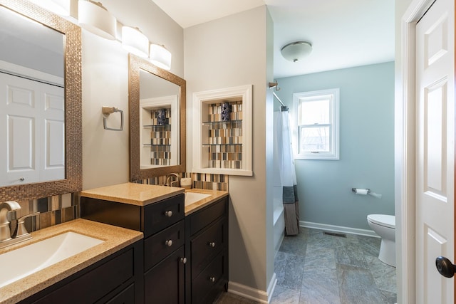 full bathroom with vanity, toilet, shower / bath combo with shower curtain, and backsplash