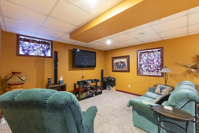 living room with carpet and a paneled ceiling