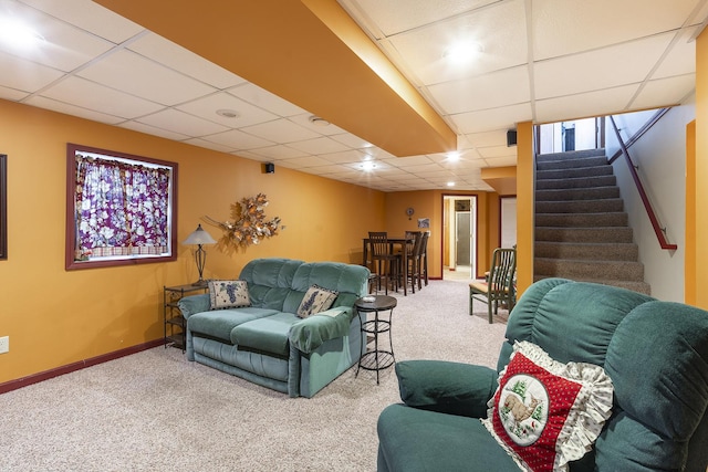 carpeted living room featuring a paneled ceiling