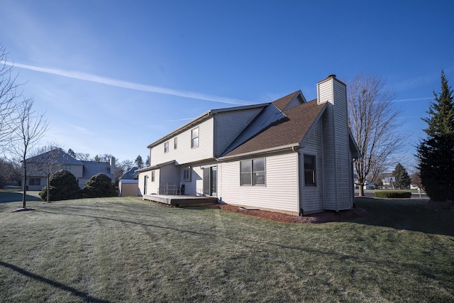 view of side of home with a lawn and a wooden deck