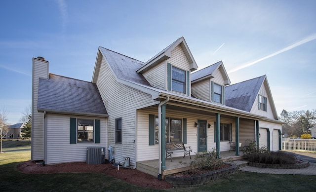 cape cod home with cooling unit and covered porch