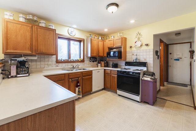 kitchen with white appliances, tasteful backsplash, and sink