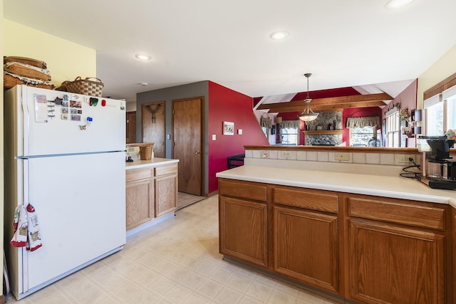 kitchen featuring pendant lighting and white refrigerator