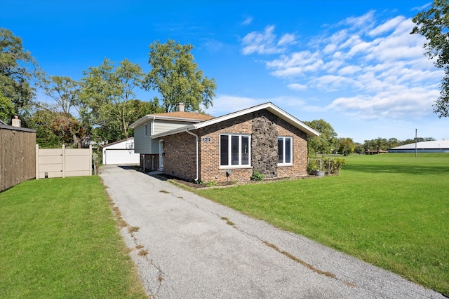 view of home's exterior featuring a yard, a garage, and an outdoor structure