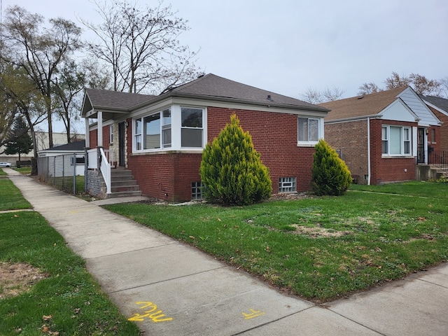 view of side of home with a lawn