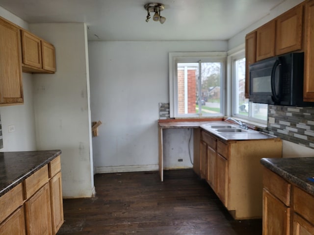 kitchen featuring tasteful backsplash, sink, and dark hardwood / wood-style floors