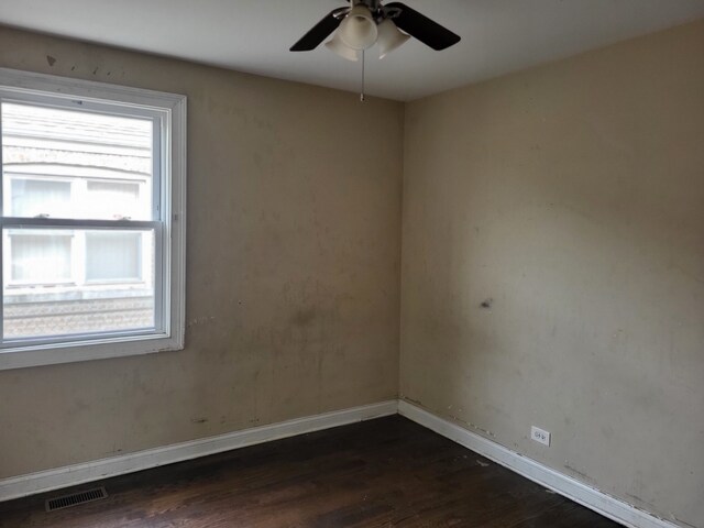 spare room featuring ceiling fan and dark wood-type flooring