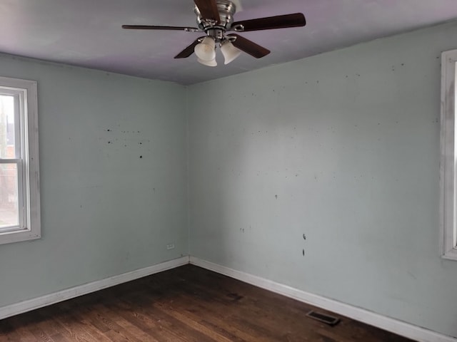 spare room with ceiling fan and dark hardwood / wood-style flooring