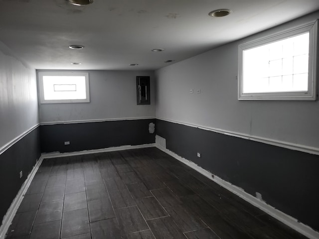 basement with dark hardwood / wood-style floors