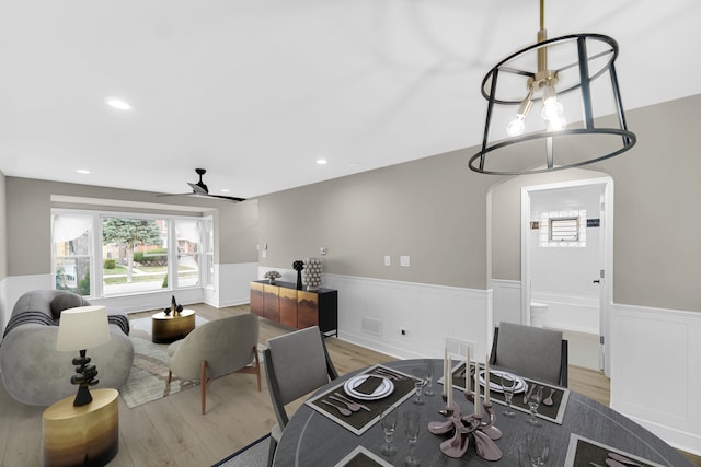 dining area featuring ceiling fan and light wood-type flooring