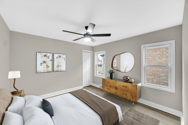 bedroom featuring ceiling fan, a closet, and light hardwood / wood-style flooring