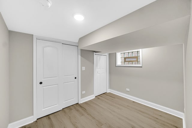 unfurnished bedroom featuring light wood-type flooring and a closet