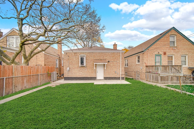 rear view of property featuring a lawn, a patio, and central AC unit