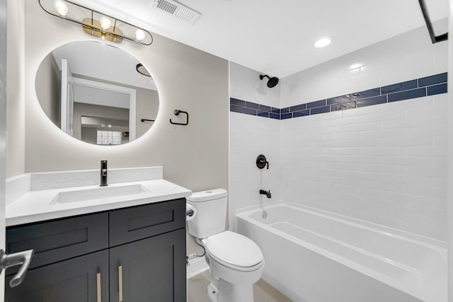 full bathroom featuring toilet, vanity, and tiled shower / bath