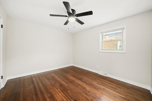 unfurnished room with ceiling fan and dark wood-type flooring