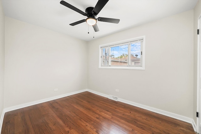 empty room featuring ceiling fan and dark hardwood / wood-style flooring