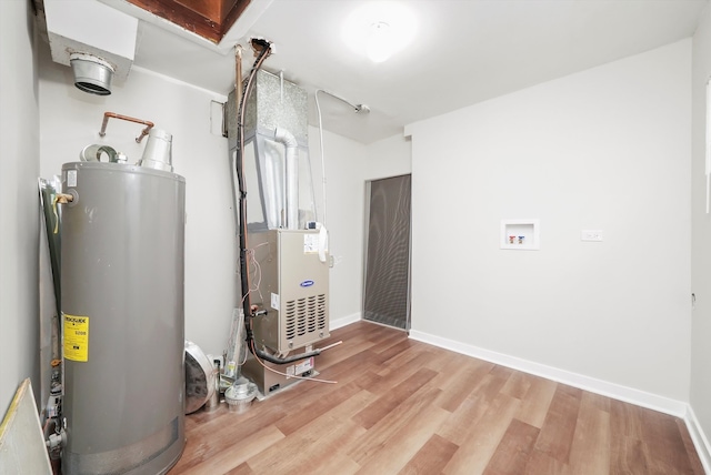 utility room featuring heating unit and water heater