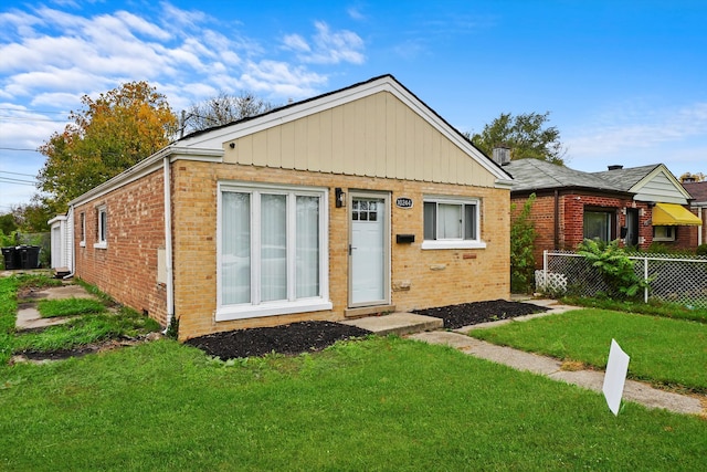 rear view of property with a lawn