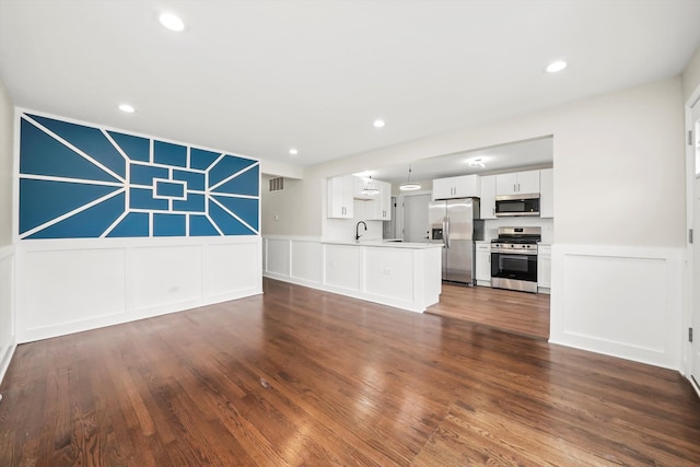 unfurnished living room with dark hardwood / wood-style flooring and sink