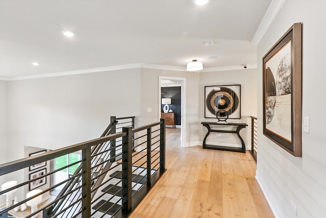 hall with light hardwood / wood-style flooring and ornamental molding