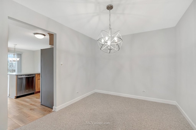 empty room featuring baseboards, a chandelier, and light colored carpet