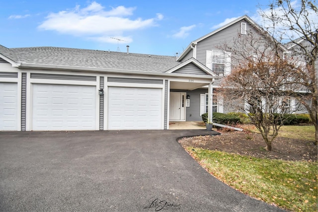 view of front of property with a shingled roof and driveway