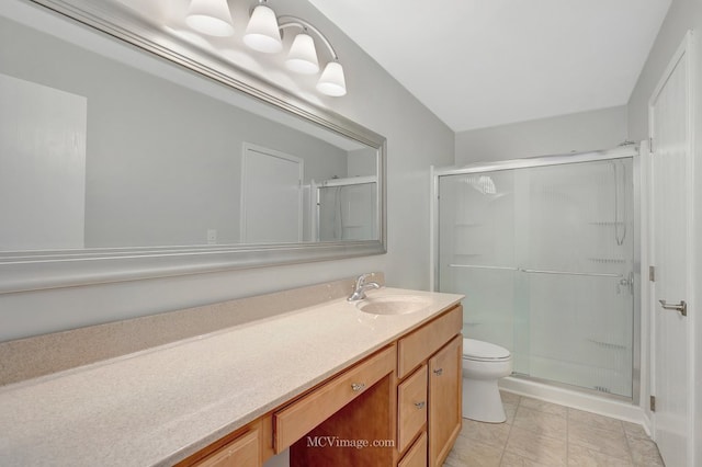 bathroom featuring toilet, a shower stall, and vanity